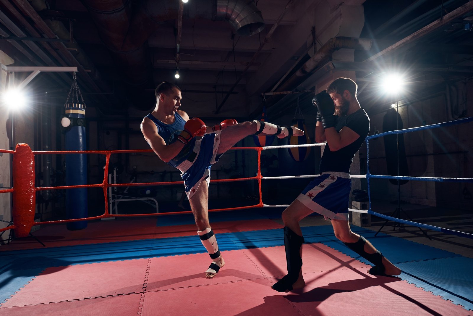 Boxers training kickboxing in the ring at the health club